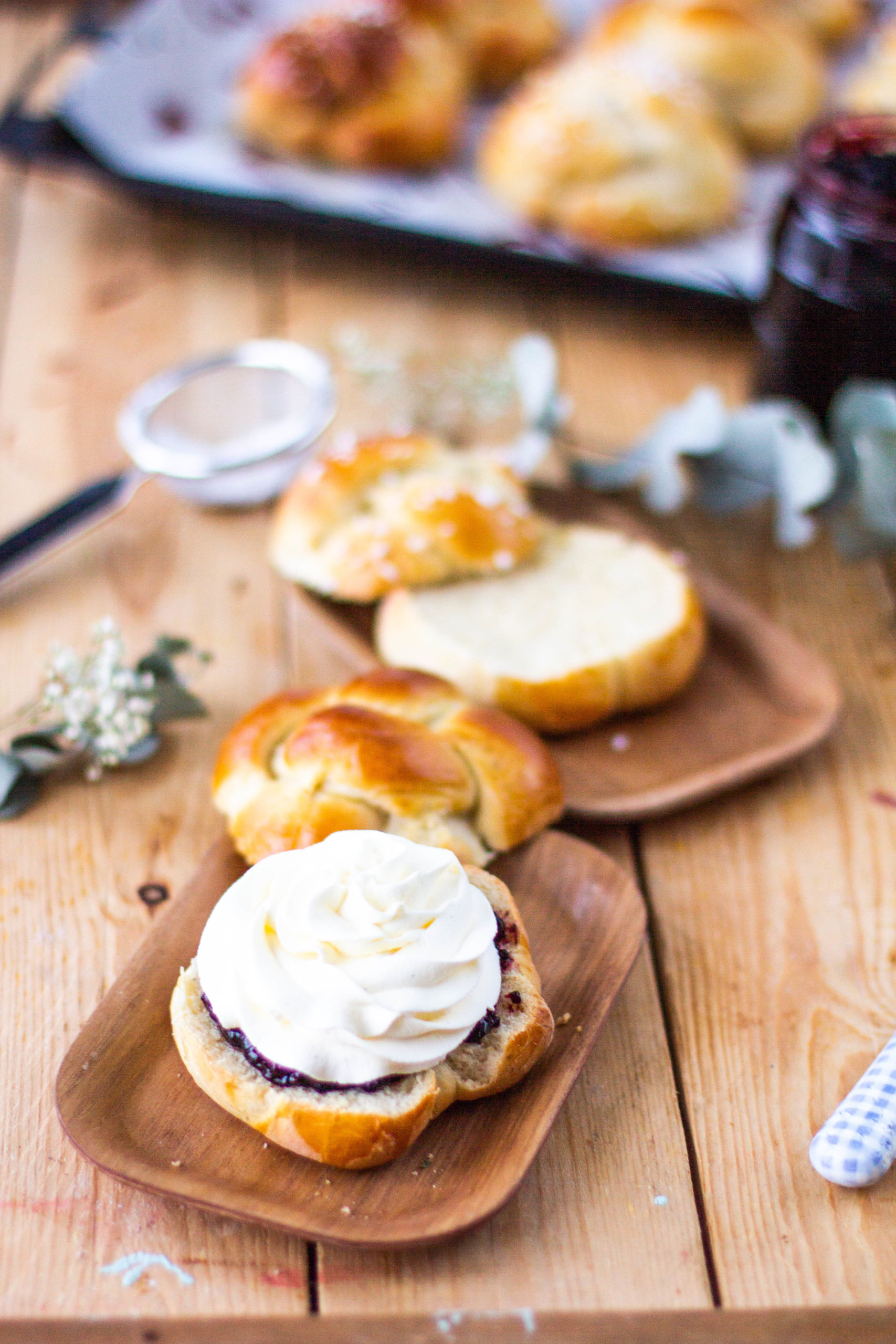 Delicious sweet roll with jam and whipped cream